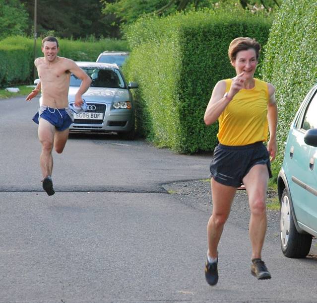 A person and person running on a street

Description automatically generated with medium confidence