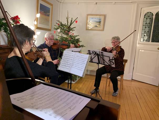 A group of people playing instruments

Description automatically generated with medium confidence