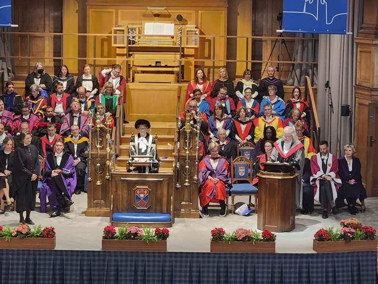 A group of people in graduation gowns

Description automatically generated